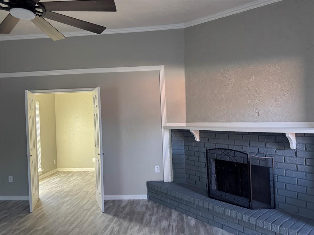 2125 Kings Road Carrollton, TX 75007 - Photo 7 of 33 a living room with a fireplace and wooden floor