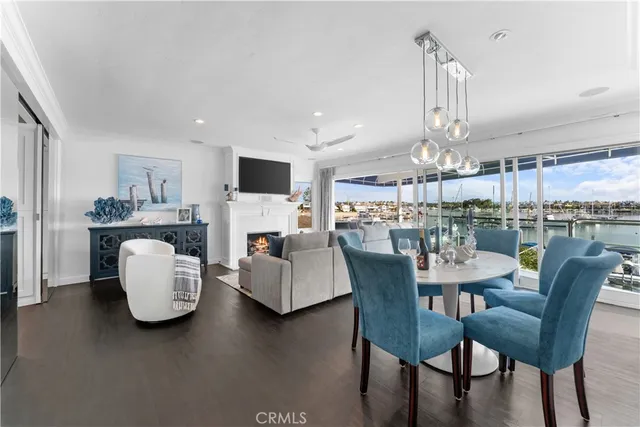 a view of a dining room with furniture a kitchen and chandelier