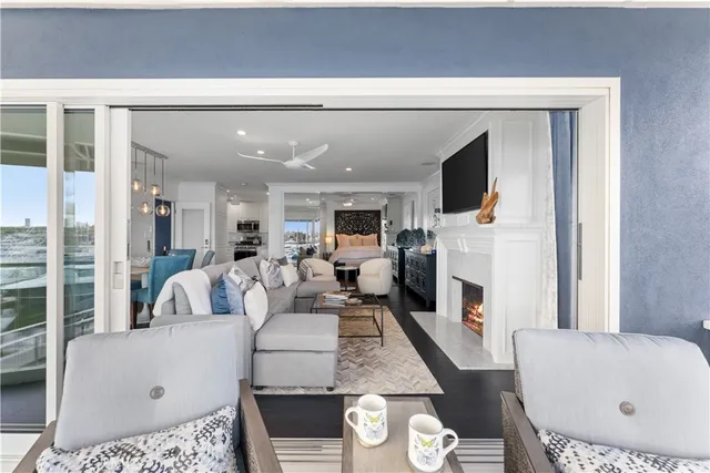 a living room with furniture a fireplace and a flat screen tv