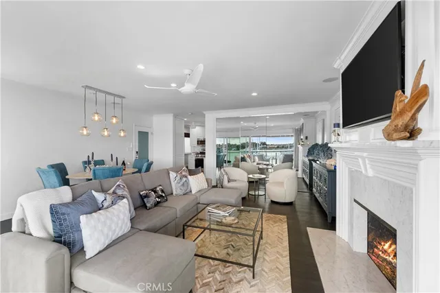 a living room with furniture a fireplace and a flat screen tv