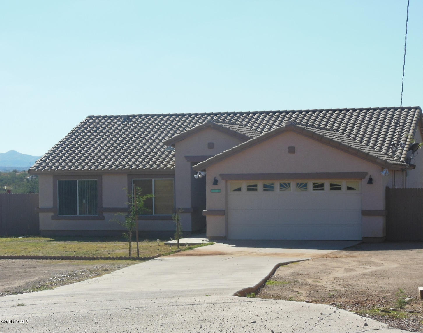 1116 Paseo Espuelas Rio Rico, AZ 85648 - Photo 1 of 26 a front view of a house with a garage