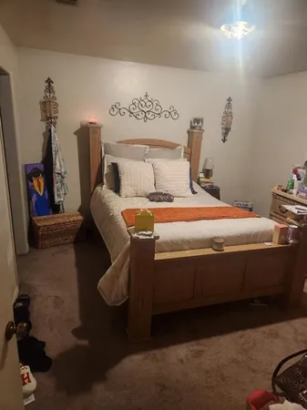 a bedroom with a bed and a couch