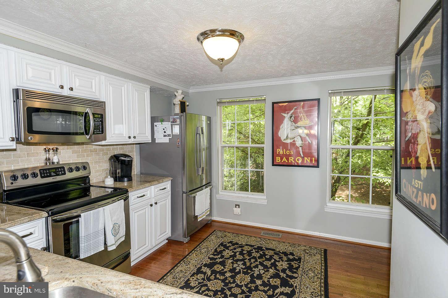 1510 Autumn Ridge Circle Reston, VA 20194 - Photo 3 of 16 a kitchen with a stove a sink and a microwave