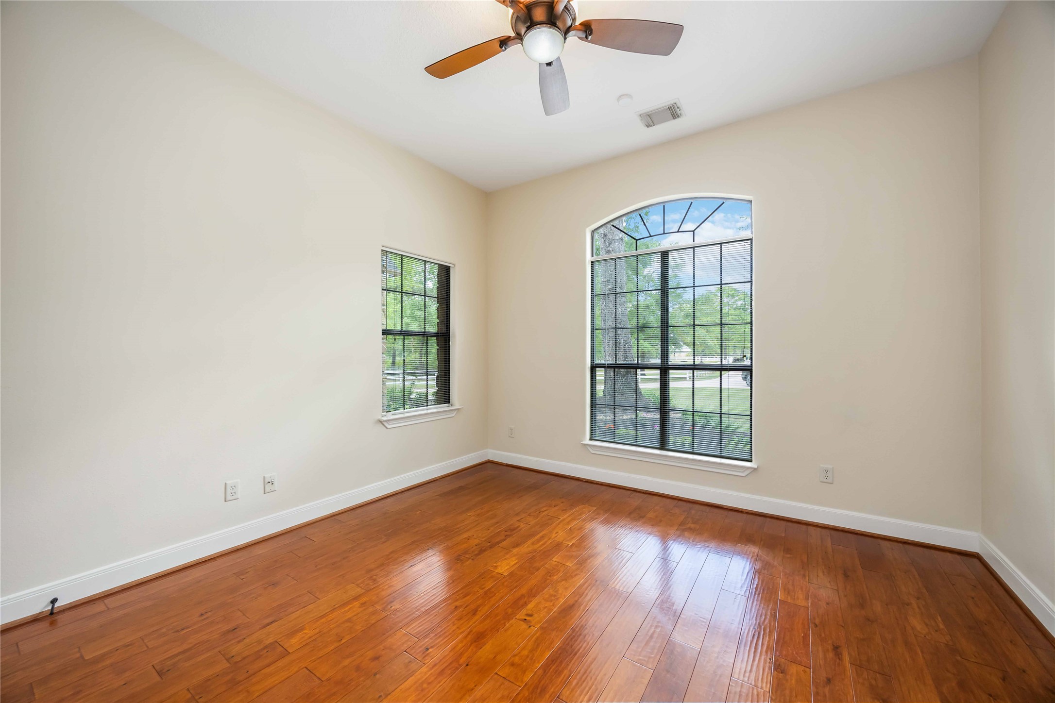 1809 St Beulah Chapel Road Montgomery, TX 77316 - Photo 17 of 50 an empty room with wooden floor chandelier fan and windows