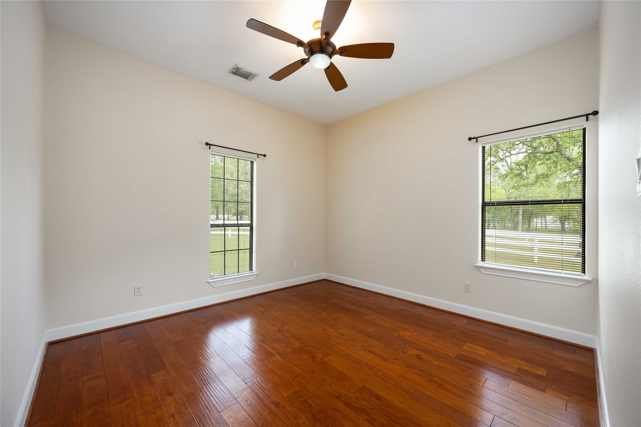 1809 St Beulah Chapel Road Montgomery, TX 77316 - Photo 19 of 50 an empty room with wooden floor ceiling fan and windows
