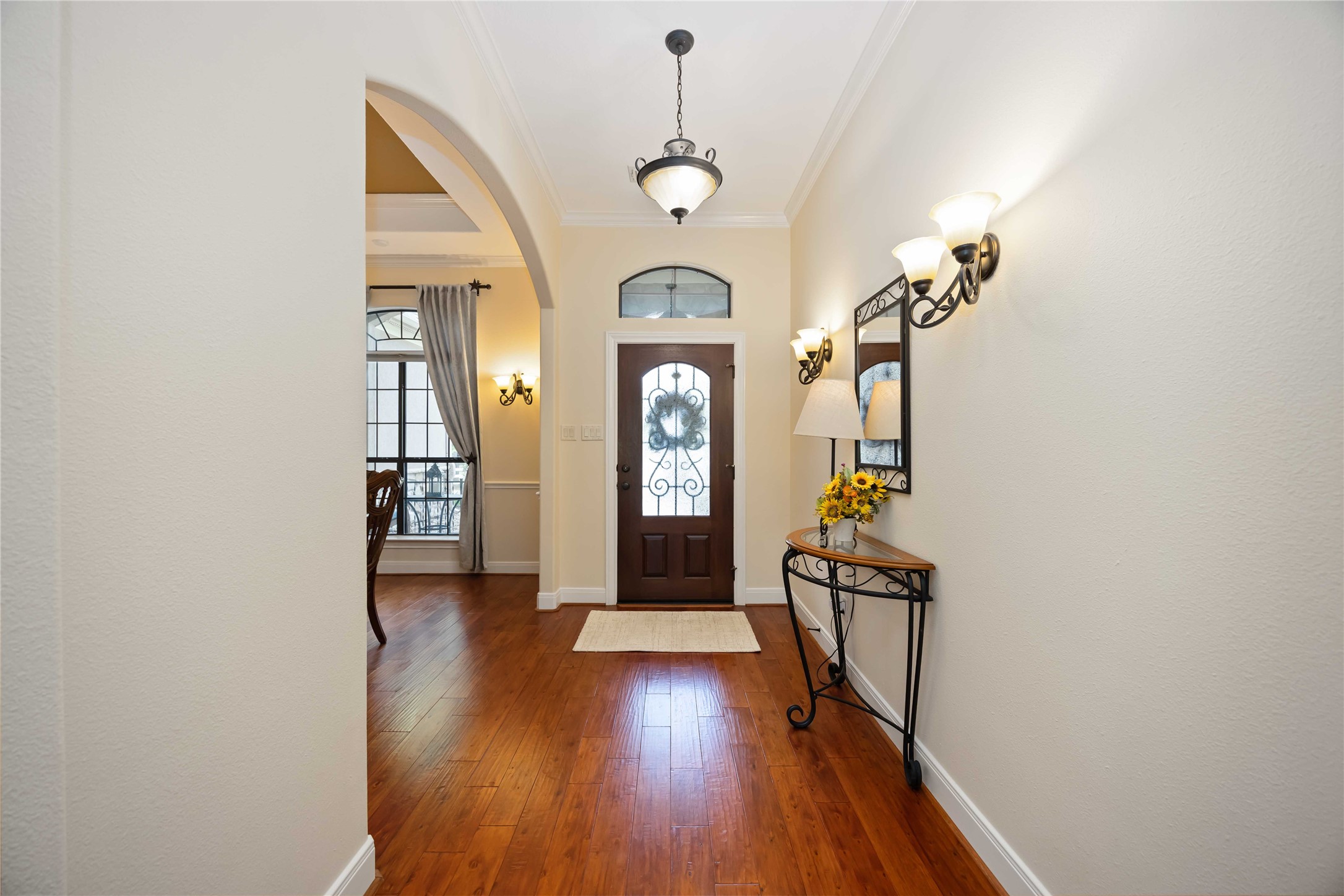 1809 St Beulah Chapel Road Montgomery, TX 77316 - Photo 4 of 50 a view of a hallway with wooden floor windows and a chandelier