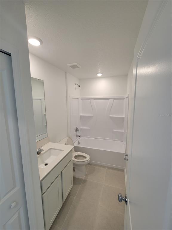 3147 Totem Road Eagle Lake, FL 33839 - Photo 10 of 18 a bathroom with a granite countertop sink a toilet and shower