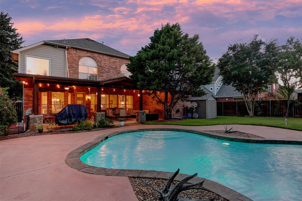 a view of a house with pool and a yard