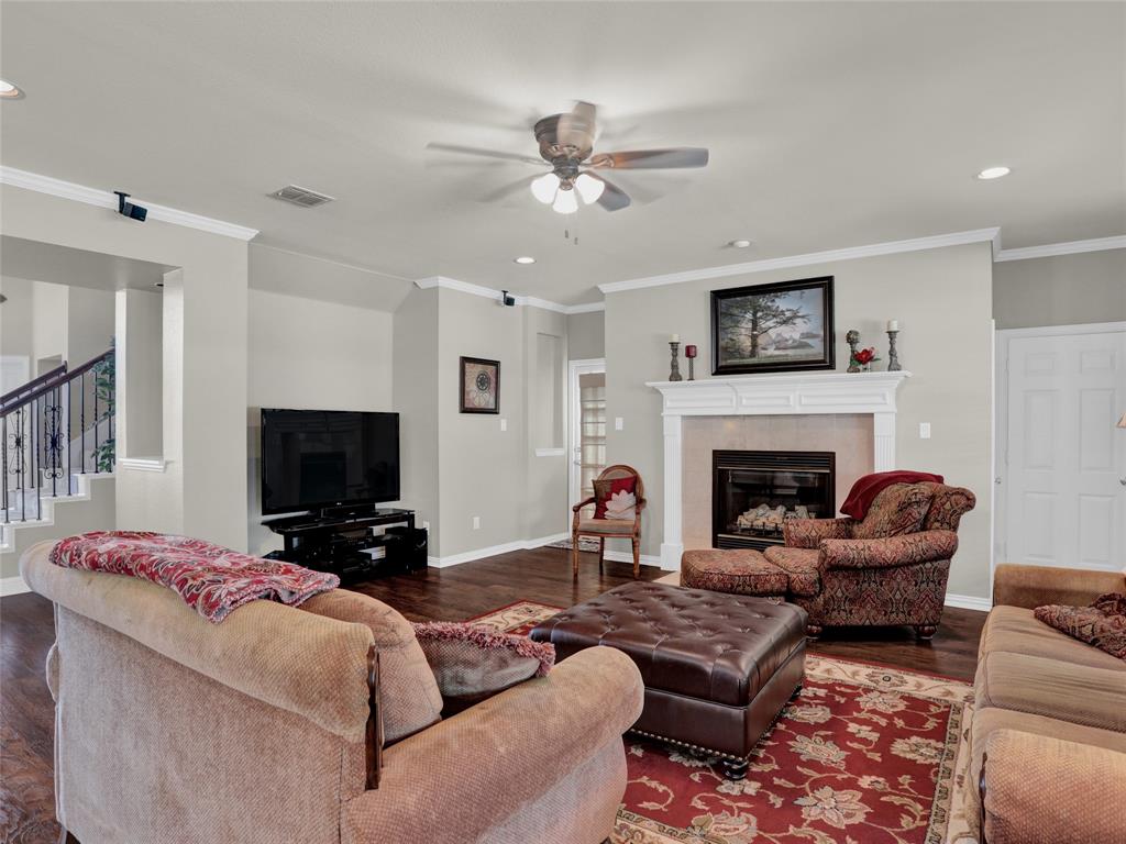 2017 Country Brook Lane Allen, TX 75002 - Photo 11 of 36 a living room with furniture a flat screen tv and a fireplace