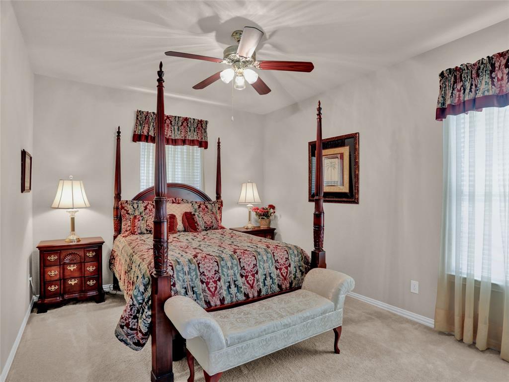 2017 Country Brook Lane Allen, TX 75002 - Photo 13 of 36 a bedroom with a bed and a chandelier