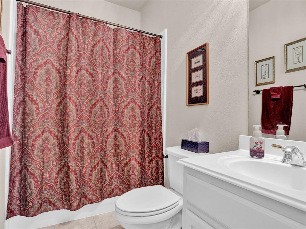 2017 Country Brook Lane Allen, TX 75002 - Photo 14 of 36 a bathroom with a toilet sink and mirror