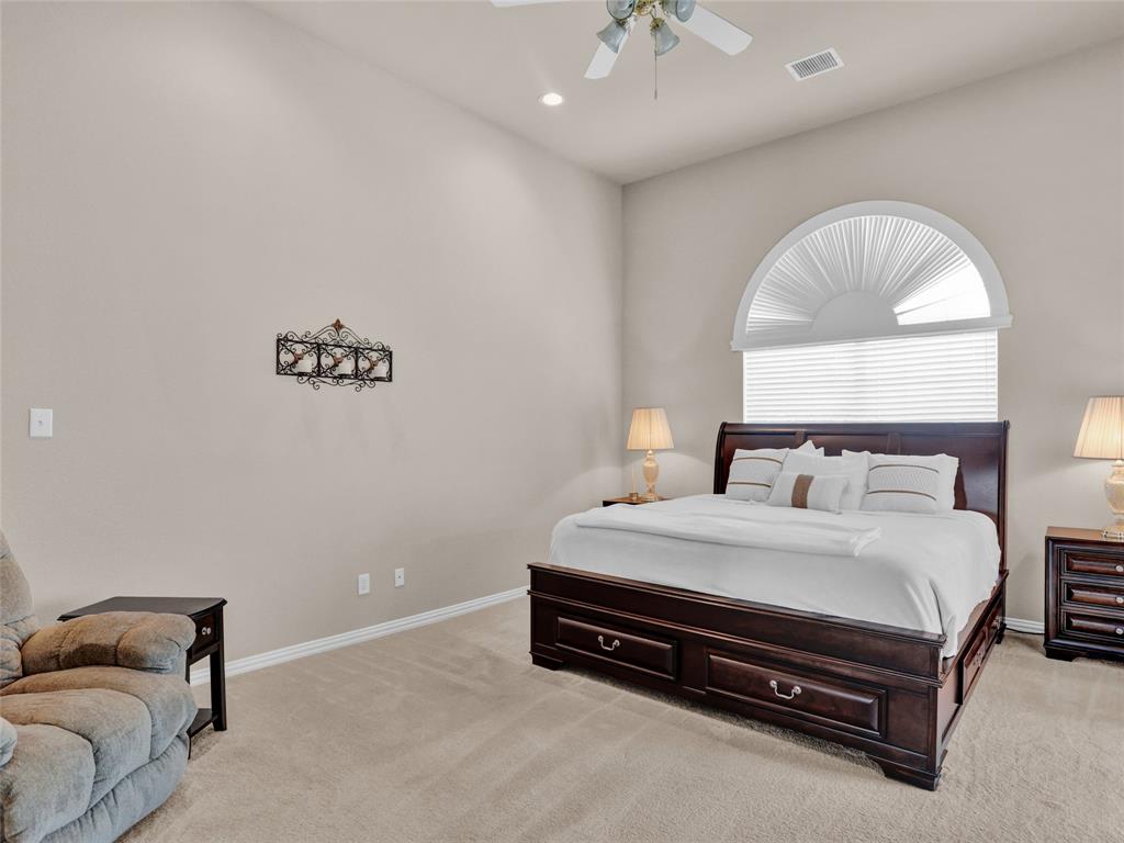 2017 Country Brook Lane Allen, TX 75002 - Photo 18 of 36 a bedroom with a bed and a chandelier