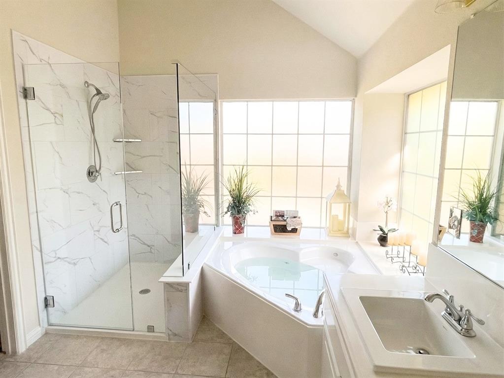 2017 Country Brook Lane Allen, TX 75002 - Photo 20 of 36 a bathroom with a tub a sink a large window and a shower