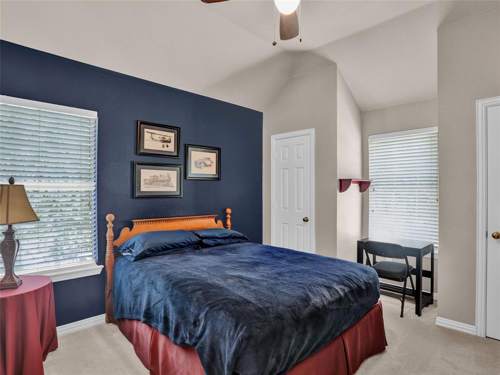 2017 Country Brook Lane Allen, TX 75002 - Photo 22 of 36 a bedroom with a bed and a lamp