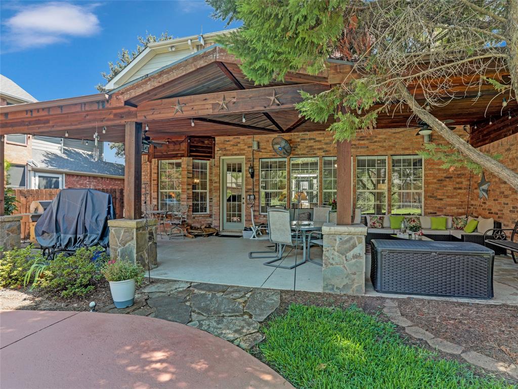 2017 Country Brook Lane Allen, TX 75002 - Photo 27 of 36 a view of a patio with table and chairs potted plants and a large tree