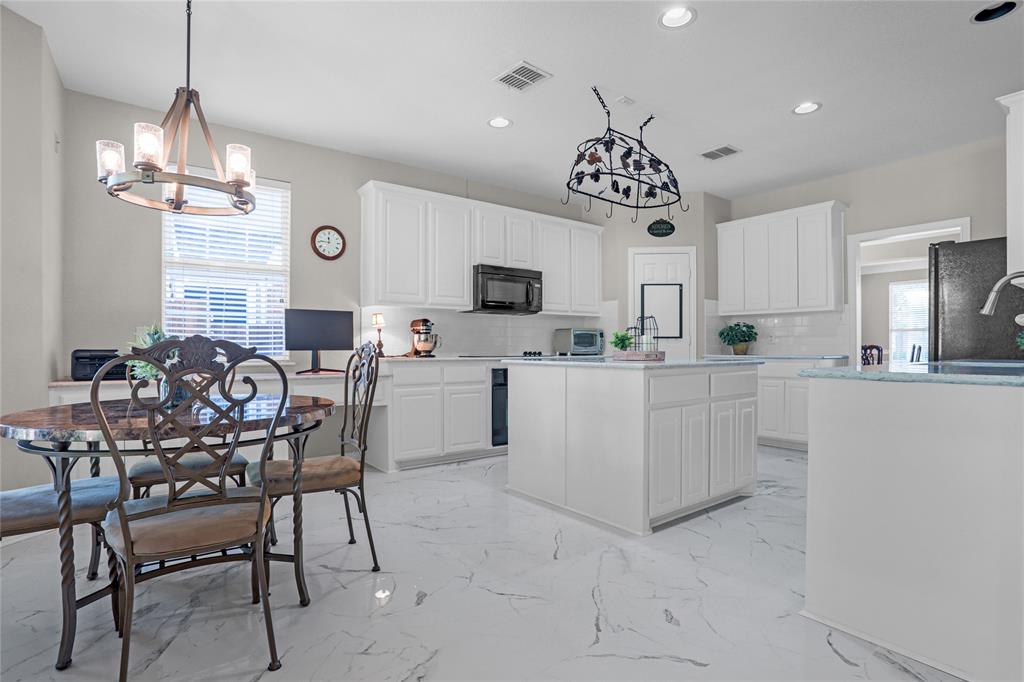 2017 Country Brook Lane Allen, TX 75002 - Photo 9 of 36 a view of kitchen with granite countertop counter top space appliances and a chandelier