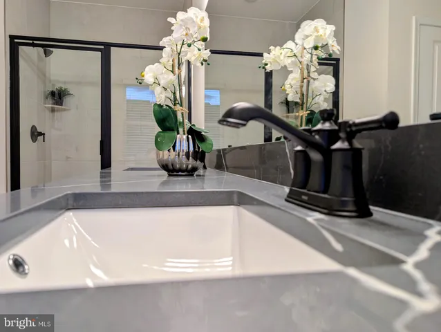 a bedroom with a bed and a lamp