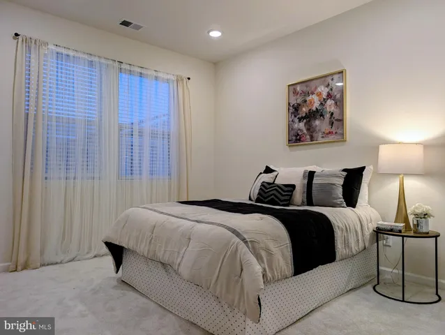 a bedroom with a bed and a lamp