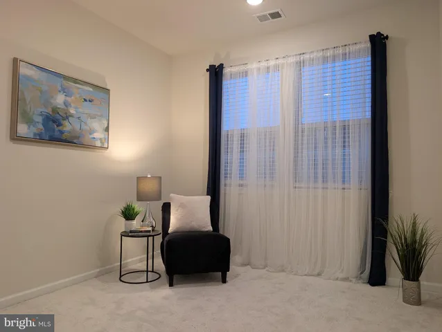 a vase of flowers sitting on a table with a potted plant