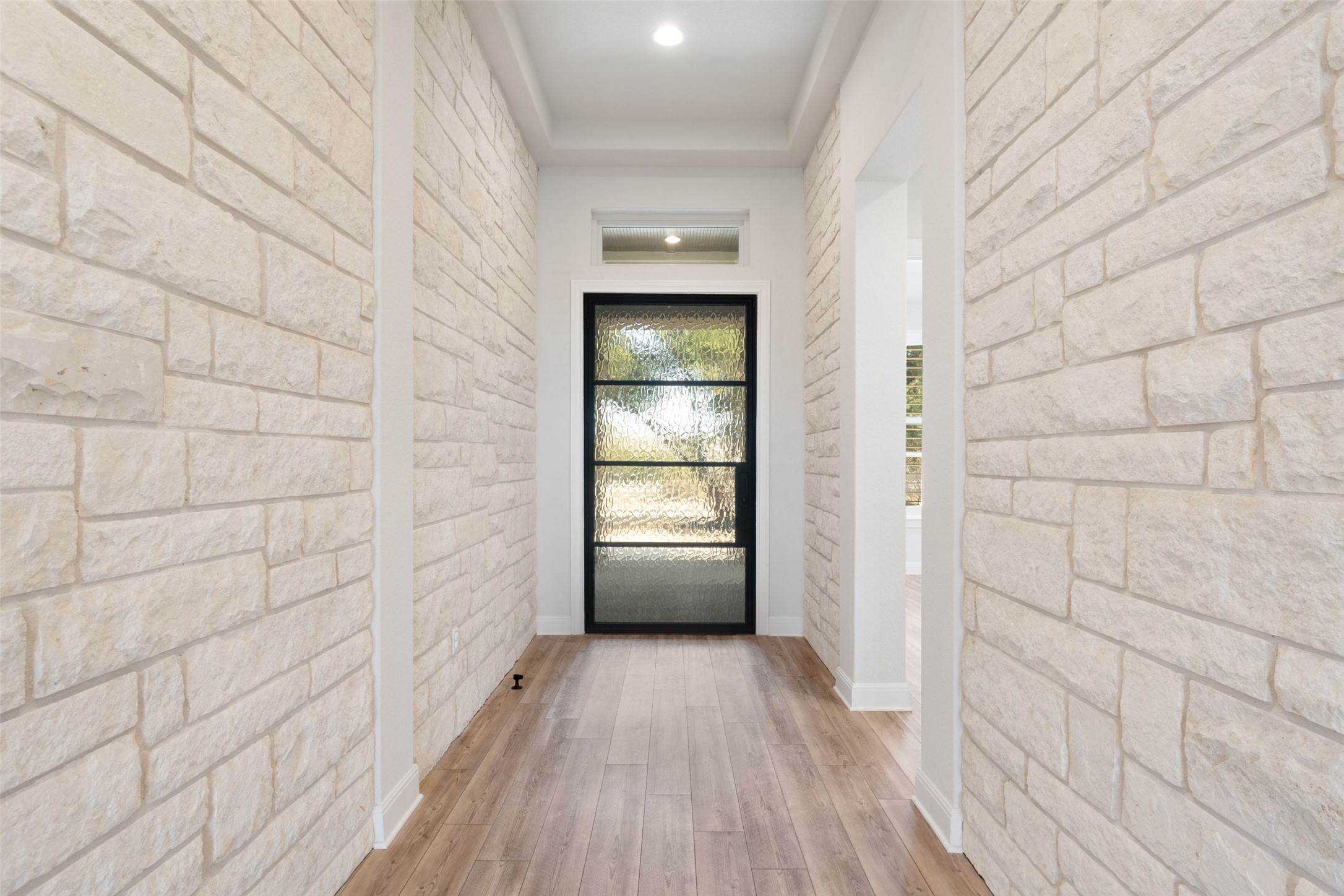 5420 Destination Way Jonestown, TX 78645 - Photo 2 of 39 Natural stone in entry hall with an oversized iron and glass front door.