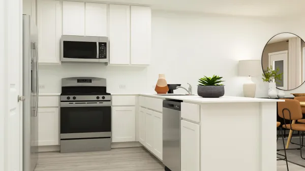 a kitchen with stainless steel appliances a stove a microwave and a white cabinets