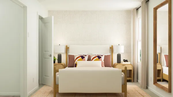 a bed sitting in a bedroom next to a window