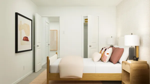 a bedroom with a bed and a lamp