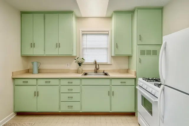 a kitchen with a sink cabinets and a refrigerator