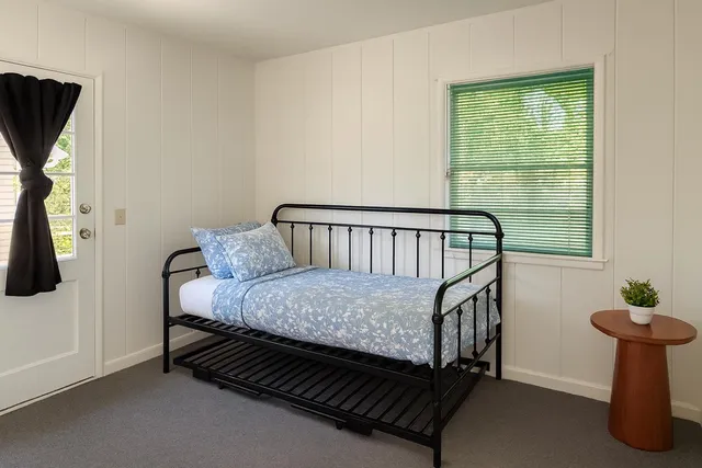 a bedroom with a bed and a window