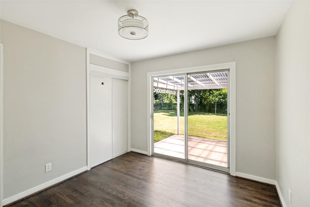 11524 Strand Street Dallas, TX 75218 - Photo 17 of 19 a view of an empty room with wooden floor and a window