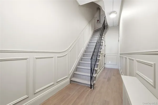 a view of a hallway with wooden floor and entryway