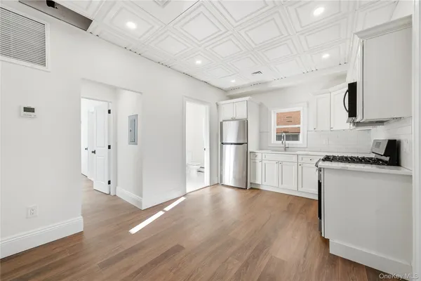 a view of a kitchen with electric appliances