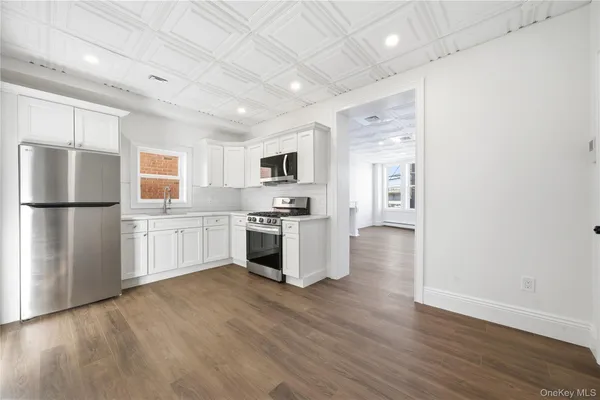 a kitchen with stainless steel appliances a refrigerator sink and cabinets