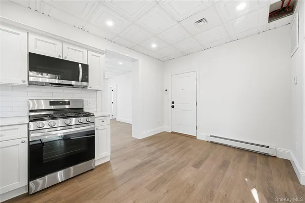 a kitchen with a stove and a microwave