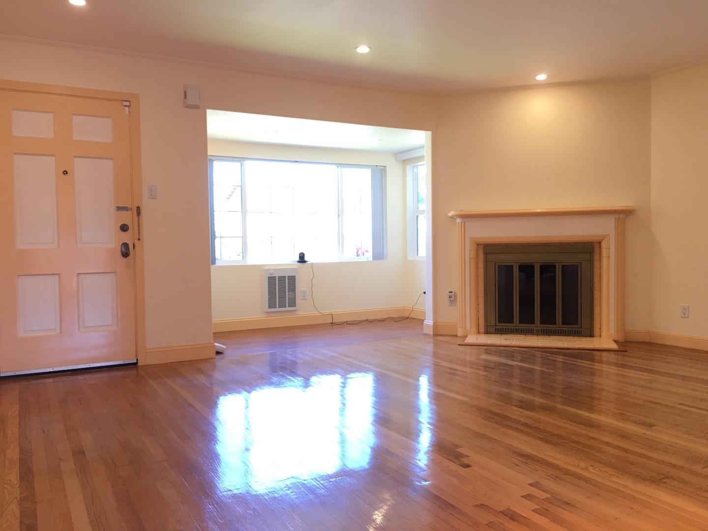 808 Ellis Drive Daly City, CA 94015 - Photo 2 of 45 an empty room with wooden floor fireplace and windows