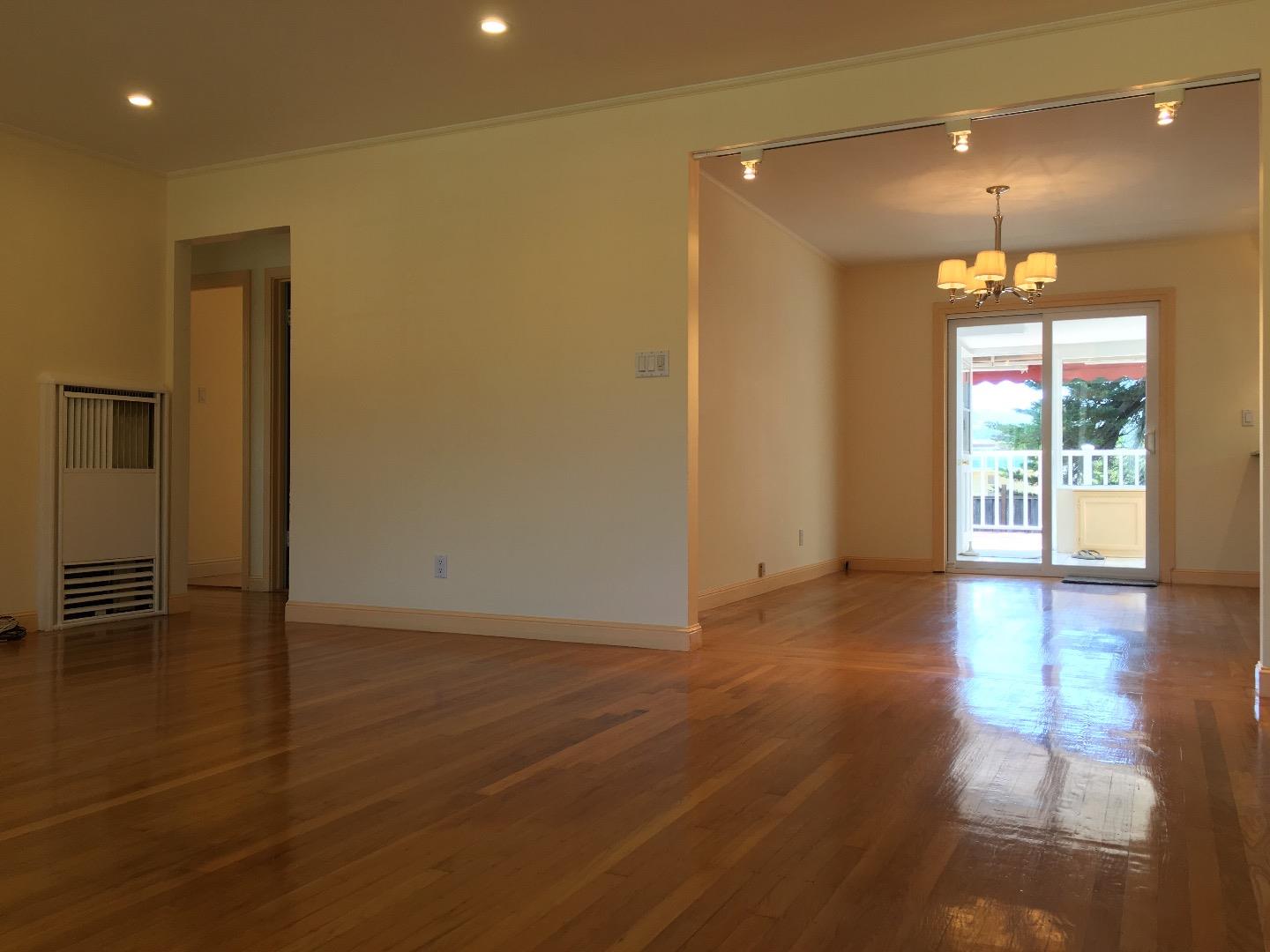 808 Ellis Drive Daly City, CA 94015 - Photo 4 of 45 an empty room with wooden floor and a window