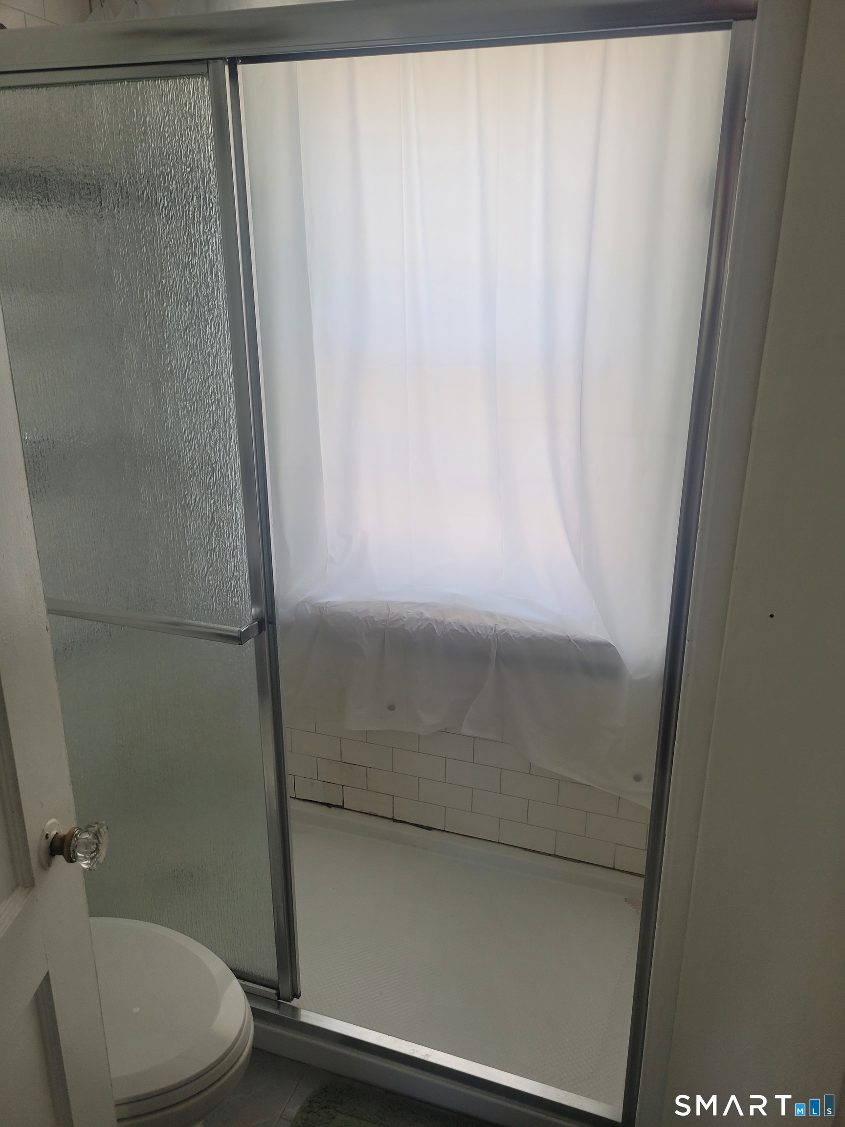 606 Wilmot Avenue, Unit 4 Bridgeport, CT 06607 - Photo 12 of 16 a bathroom with a shower and a toilet