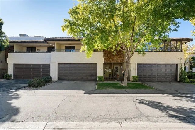 a front view of a house with a yard and a garage