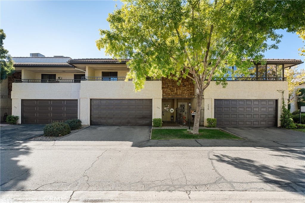 a front view of a house with a yard and a garage
