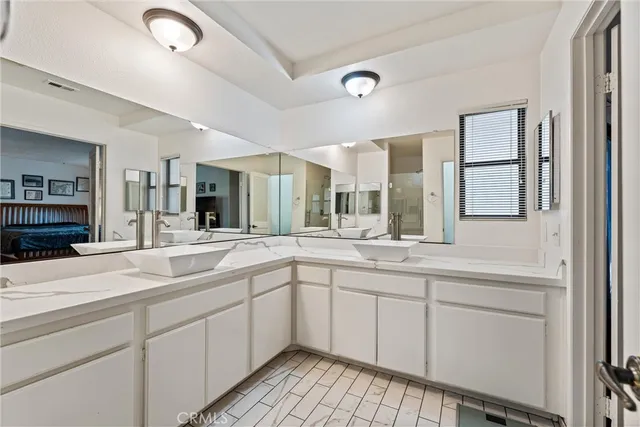 a spacious bathroom with a sink and mirror