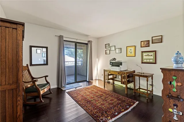 a view of a livingroom with furniture and a workspace