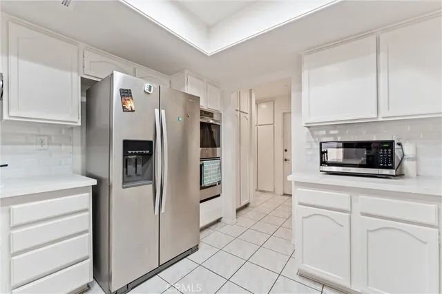 a kitchen with stainless steel appliances a refrigerator and a stove top oven