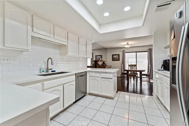 a kitchen with a sink window and cabinets