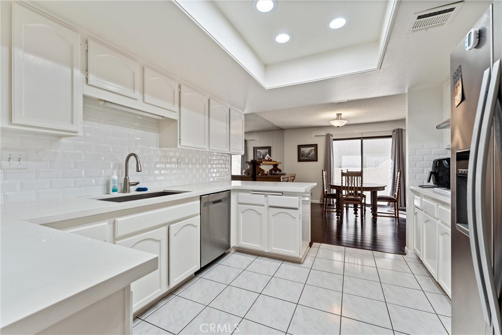 236 Hawk Lane Palmdale, CA 93551 - Photo 7 of 32 a kitchen with a sink window and cabinets