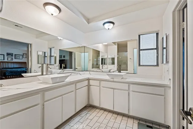 a spacious bathroom with a sink and mirror