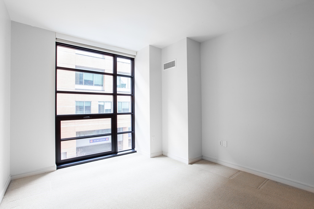 580 Washington Street, Unit 304 Boston, MA 02111 - Photo 13 of 18 a view of an empty room with a window