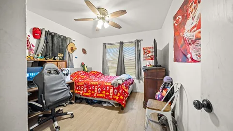 a bedroom with bed and a chandelier