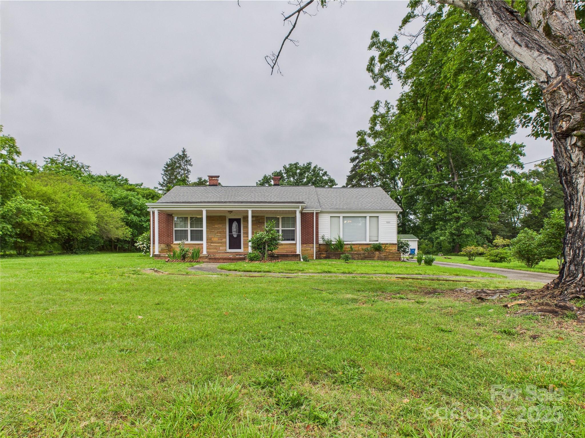 a front view of a house with a garden