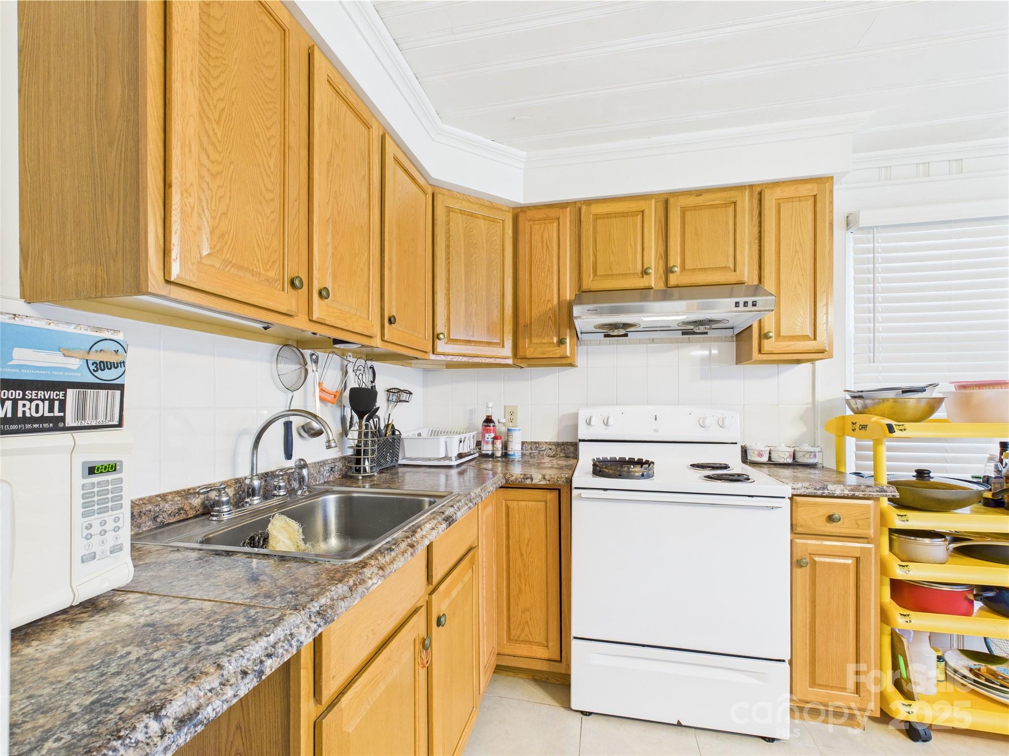 3055 16th Street Northeast Hickory, NC 28601 - Photo 12 of 46 a kitchen with a sink stove and cabinets
