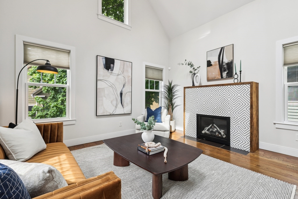a living room with furniture fireplace and window